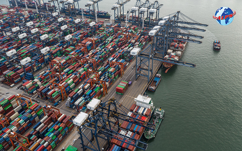 aerial view of a busy port with numerous stacked shipping containers