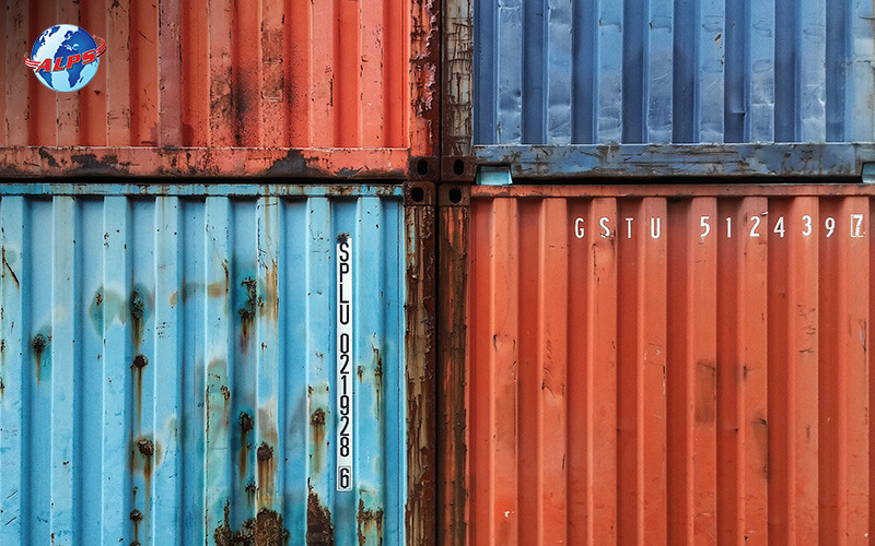 weathered and battered containers stacked on top of each other